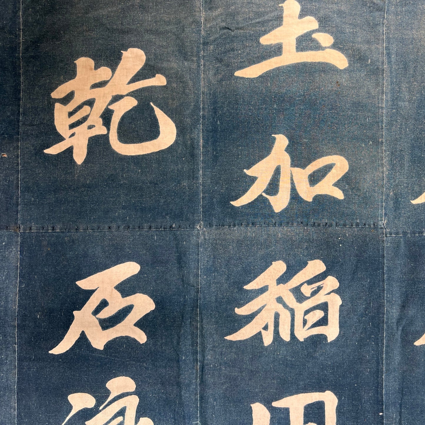 Close-up of Japanese characters on an indigo patchwork background