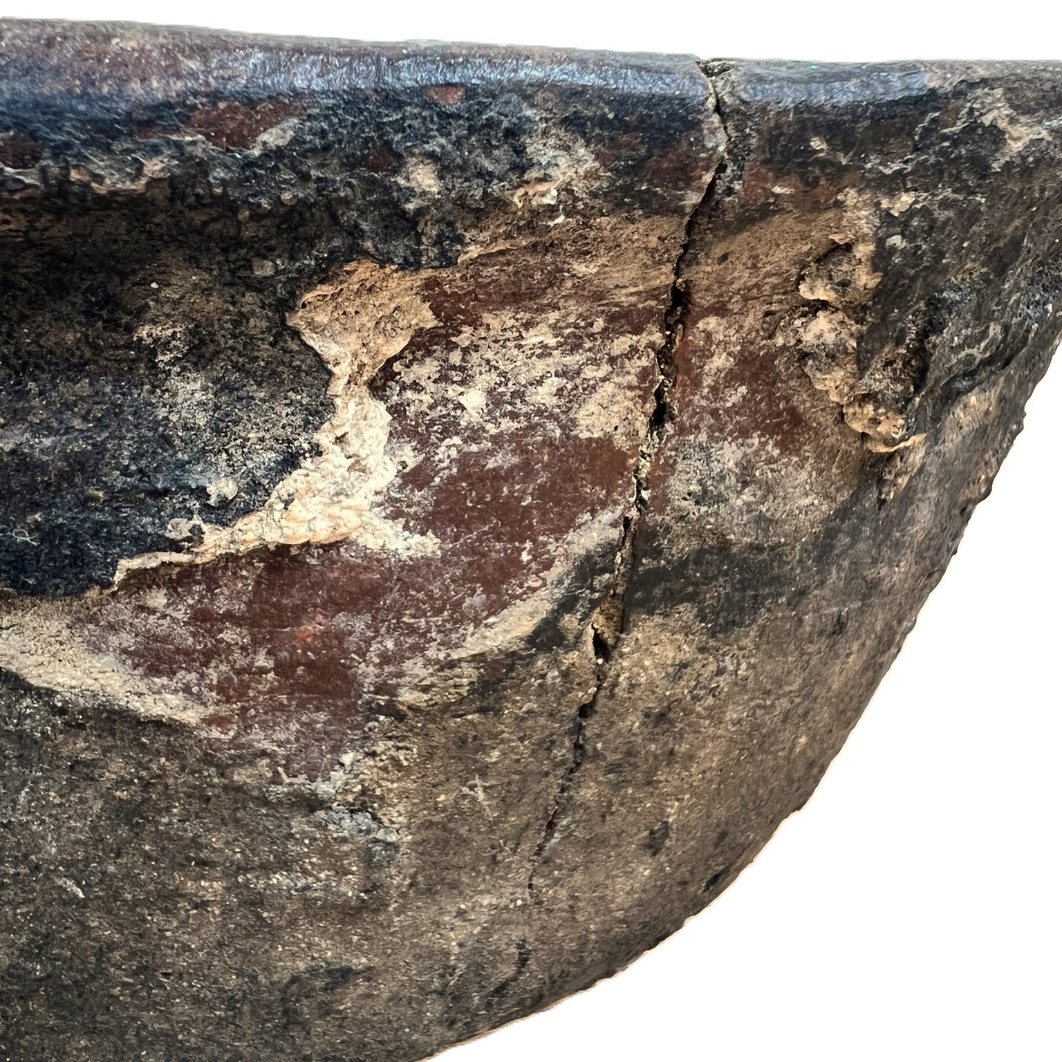 Close-up of a rough-textured stone object with cracks and natural variations.