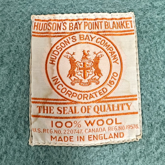 Hudson's Bay Point Blanket label with branding and text on a textured teal wool blanket