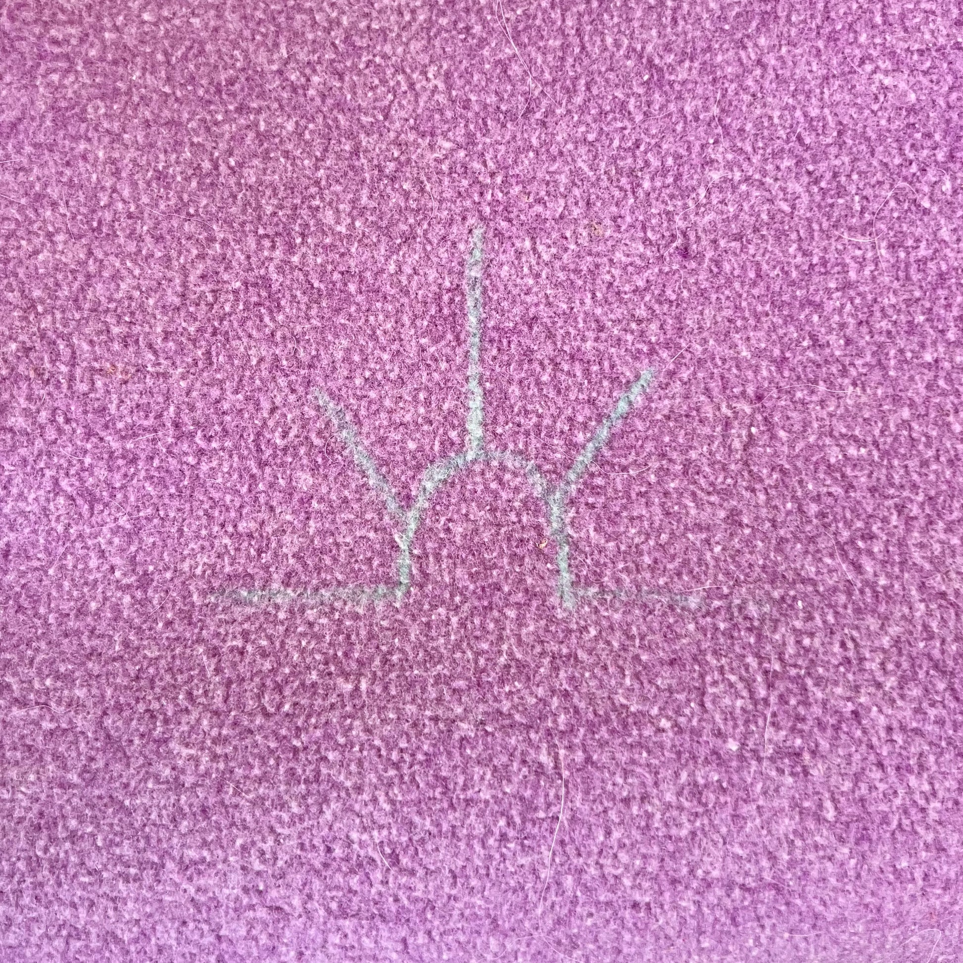 Close-up of a Baron Wool Blanket mark on purple wool