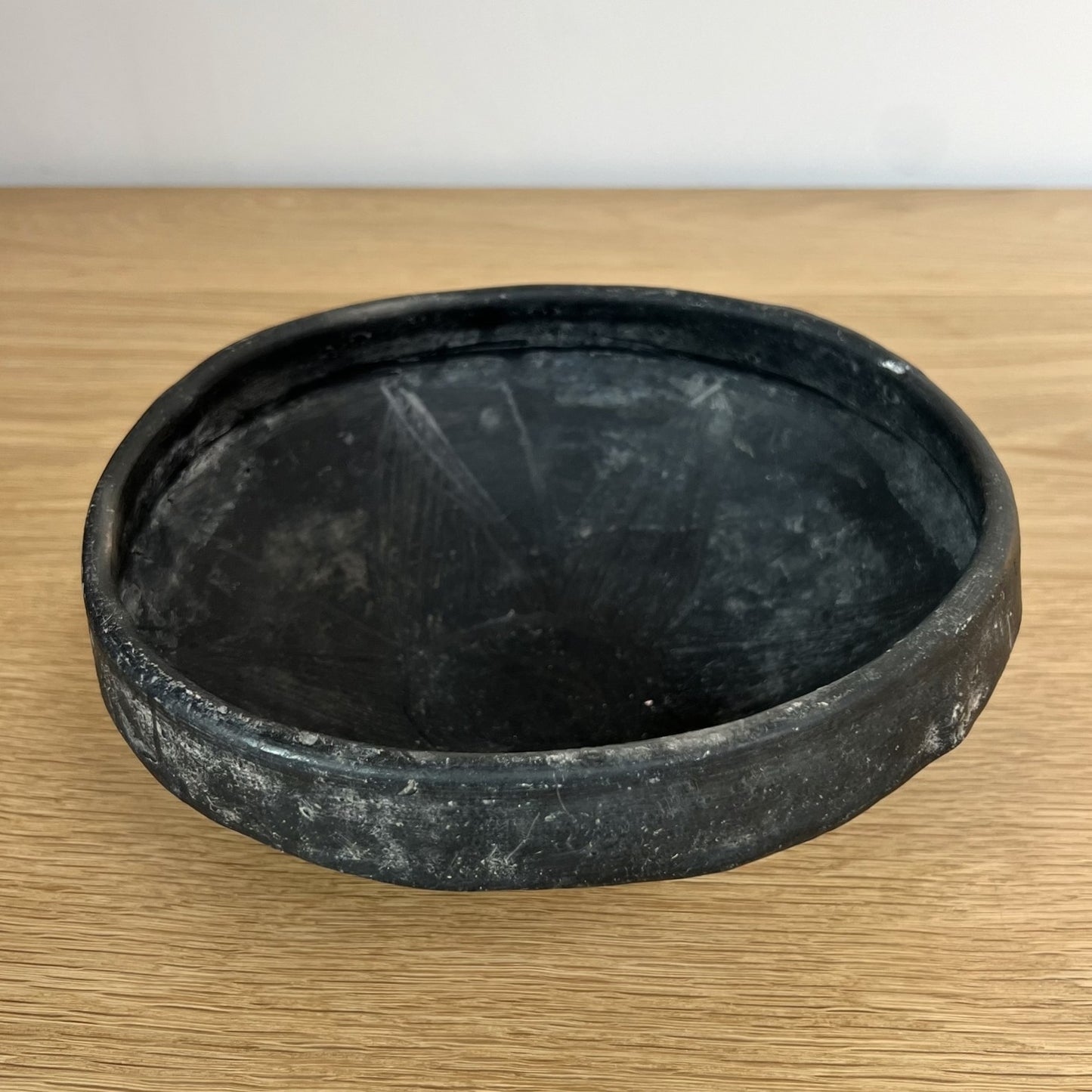 Black ceramic bowl on a wooden surface