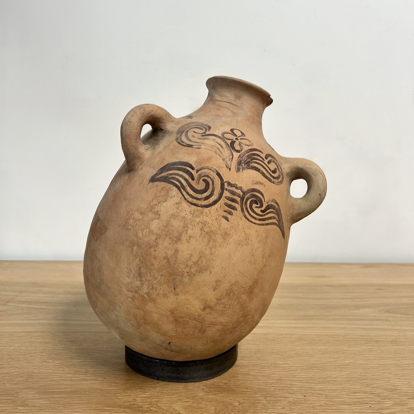 Ceramic vase with decorative patterns on a wooden surface