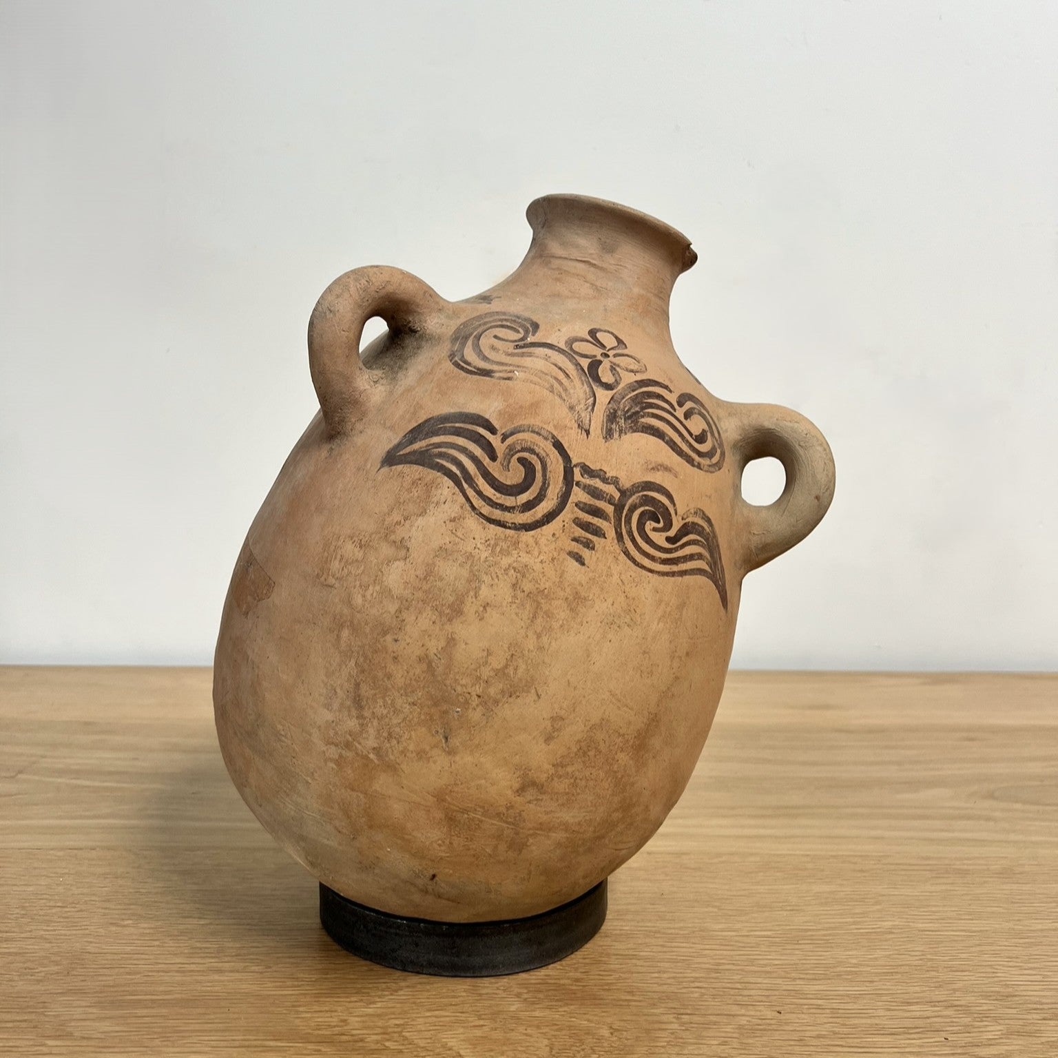 Ceramic vase with decorative patterns on a wooden surface